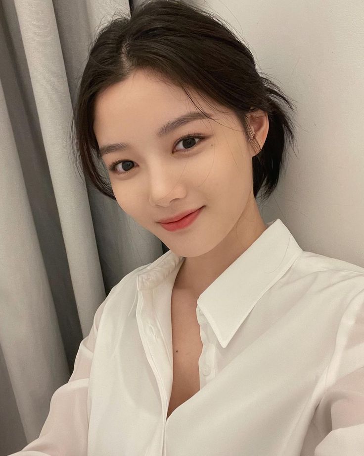 Foto close-up Kim Yoo Jung dengan riasan natural, menunjukkan kecantikan dan ekspresi lembut khasnya.